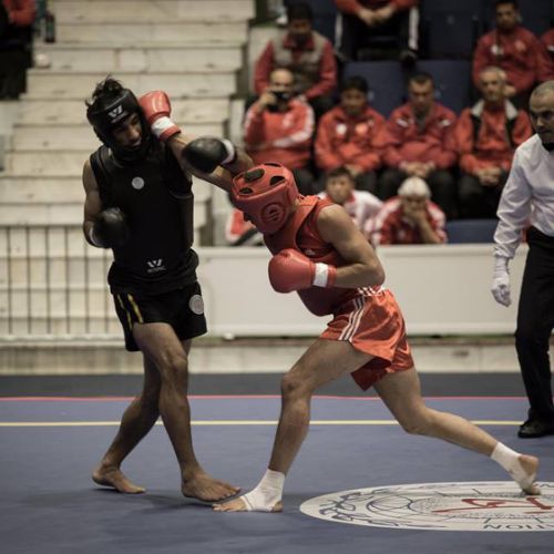 Thomas Nguyen (en rouge) pendant le Championnat du monde de Sanda 2014.